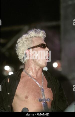 English rock musician Billy Idol is shown performing on stage during his set at Rock in Rio II. Stock Photo