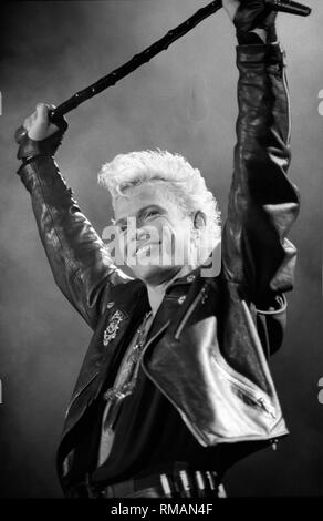 Singer Billy Idol is shown performing on stage during a 'live' concert appearance. Stock Photo