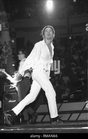 Singer Michael Hutchence is shown performing on stage during a 'live' concert appearance with INXS. Stock Photo