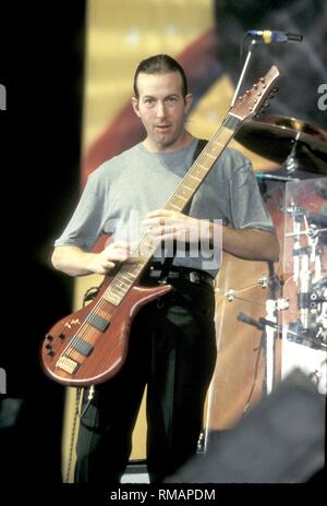 Musician Trey Gunn of the progressive rock band King Crimson is shown performing on stage during a 'live' concert appearance. Stock Photo