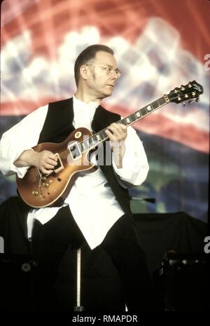 King Crimson founder Robert Fripp is shown performing on stage during a 'live' concert appearance. Stock Photo