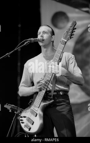 Bassist Trey Gunn of the progressive rock band King Crimson is shown performing on stage during a 'live' concert appearance. Stock Photo