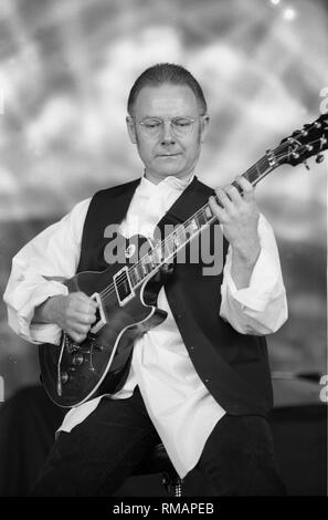 King Crimson founder Robert Fripp is shown performing on stage during a 'live' concert appearance. Stock Photo