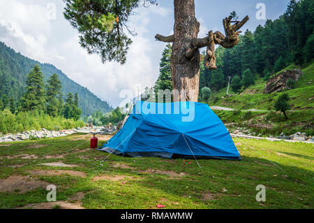 Blue coloured tent set up for camping in the Himalayan region of Kashmir Stock Photo