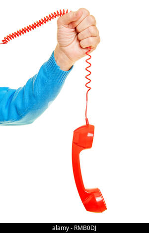 Male hand is holding a red telephone receiver on the cable Stock Photo