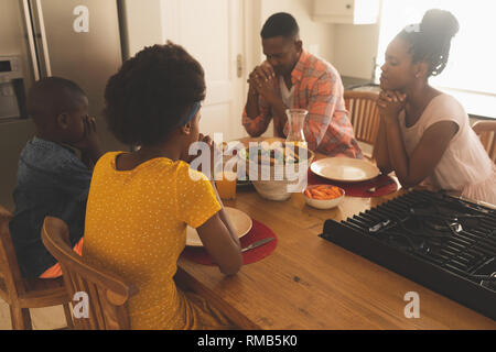 African American family praying together at home Stock Photo