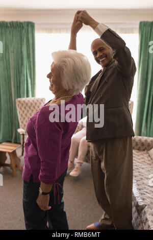 Happy senior couple dancing together at home Stock Photo