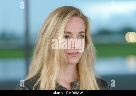 Portrait of young blond woman looking away, side view Stock Photo