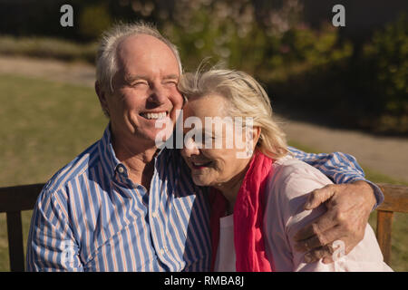 Senior couple embracing each other in the park Stock Photo