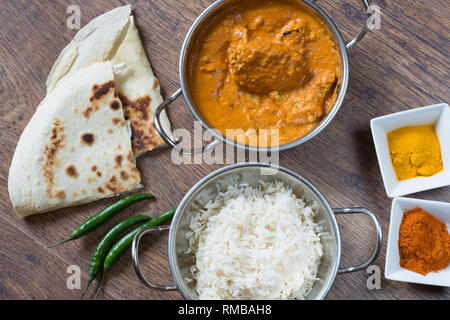 Popular Indian dish of Chicken tikka masala with boiled rice and naan breads, Stock Photo