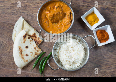 Popular Indian dish of Chicken tikka masala with boiled rice and naan breads, Stock Photo