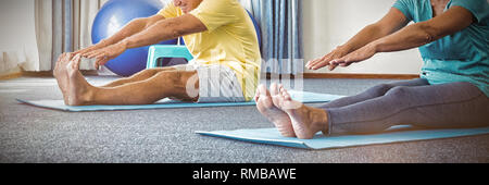 Side view of seniors doing exercises Stock Photo