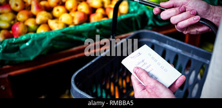 Man holding shopping basket and checklist Stock Photo