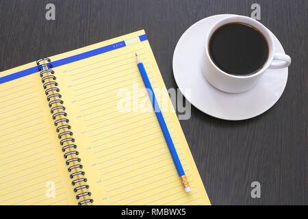 Open diary, planner with pencil and espresso coffee on an old wooden table Stock Photo