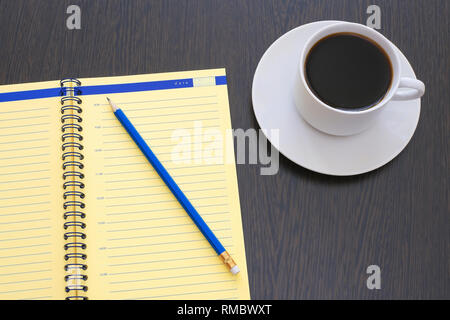 Open diary, planner with pencil and espresso coffee on an old wooden table Stock Photo