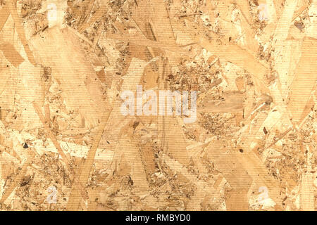 OSB panel rear side front view closeup Oriented Strand Board rear side front view close up. Chipboard building material made of pressed sandy brown wo Stock Photo