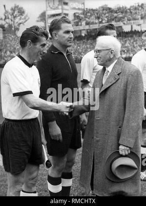 The President of FIFA Jules Rimet (r) welcomes the captain of the German national team Fritz Walter before the final of the 1954 FIFA World Cup. Stock Photo