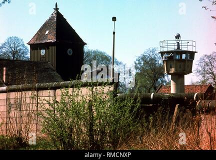 View from Staaken over the Berlin Wall towards east, where, at right, there is a watchtower, photographed from Berlin-West in the years 1984-1987. Stock Photo