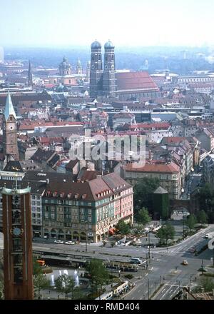 The old town of Munich towards North East. The Sendlinger Tor with square and fountain and left in the picture the Kreuzkirche. So is the medieval Munich presented in the 2nd wall ring. The towers of the Frauenkirche as the center, in the background the English Garden. Stock Photo