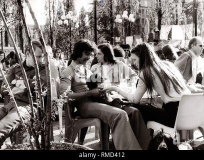 Seventies: Saturday afternoon in Schwabing, Leopoldstrasse, young people in the street cafe of Citta 2000, 1975. Stock Photo