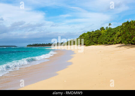 Shore of an azure, turquoise, blue lagoon. Waves, surf, swash at a remote empty idyllic sandy beach on Foa island, Haapai islands or Ha'apai group, To Stock Photo