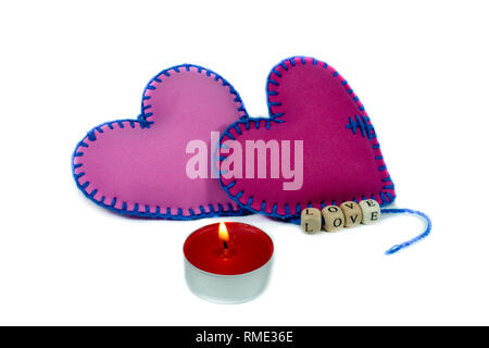 Hand stitched textile hearts with word Love on blocks threaded on strings isolated on white background for romantic relationship, Valentines Day, brok Stock Photo