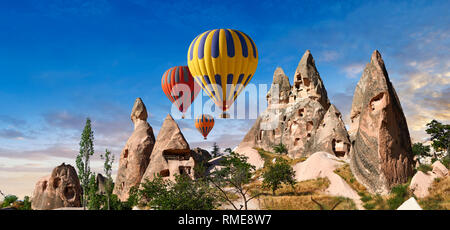 Pictures & images of hot air balloons over Uchisar Castle & cave  houses in fairy chimney of Uchisar, near Goreme, Cappadocia, Nevsehir, Turkey Stock Photo