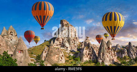 Pictures & images of hot air balloons over Uchisar Castle & cave  houses in fairy chimney of Uchisar, near Goreme, Cappadocia, Nevsehir, Turkey Stock Photo
