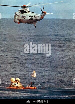 After landing in the Pacific, the 'Odyssey' Command Module of Apollo 13 is salvaged by a helicopter. The goal of Apollo 13 was the third manned Moon landing of NASA. Due to an explosion in one of the oxygen tanks, Apollo 13 had to cancel its mission before the intended landing on the Moon. Stock Photo