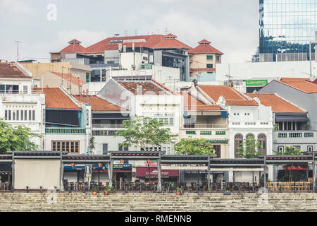 Singapore / Singapore - February 10 2019: Tourist attraction Boat Quay at Raffles Place shophouse restaurants and bars with commercial office building Stock Photo