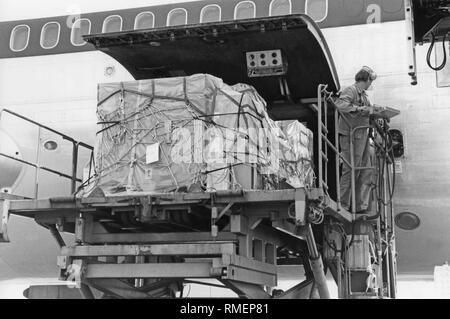Loading pallets with freight into a Lufthansa machine. Stock Photo