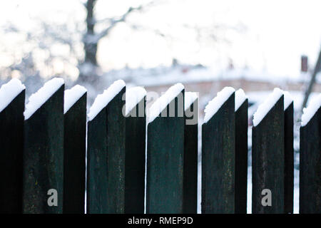 Winter view of old wood fence with small amount of snow on it. Stock Photo