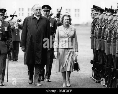Chancellor Helmut Kohl and British Prime Minister Margaret Thatcher visit a British base in Germany (Lueneburg Heath or Sennelage), here, inspecting an honour guard of the Rhine Army. Stock Photo