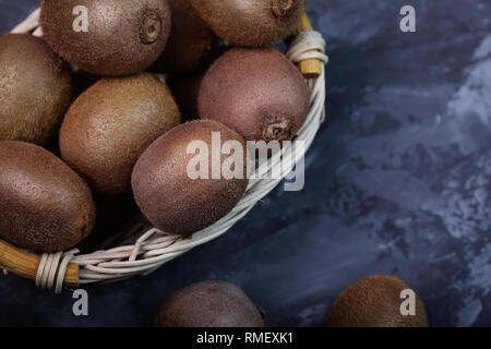 juicy ripe pieces of kiwi on a dark background Stock Photo