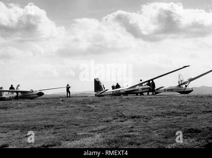 Glider pilots and planes on the Wasserkuppe in the Rhön or Rhoen Mountains. Stock Photo