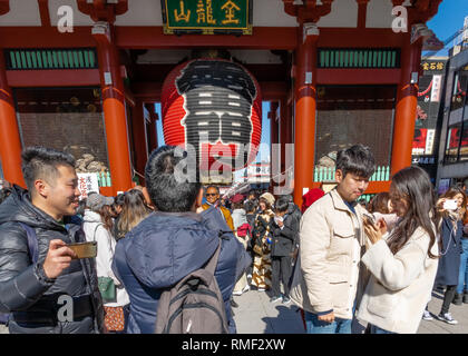 TOKYO, JAPAN - FEBRUARY 1, 2019: Crowd of tourists by giant red lantern in Kaminarimon Gate of Senso-ji Temple in Asakusa area. It is also known as Th Stock Photo