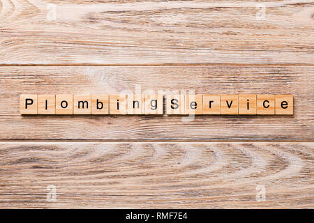 Plumbing service word written on wood block. Plumbing service text on wooden table for your desing, concept. Stock Photo