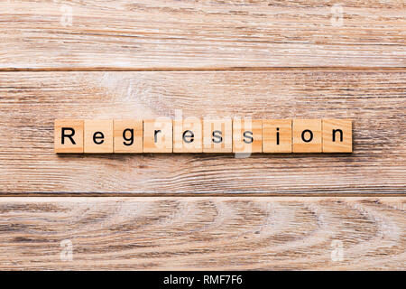 regression word written on wood block. regression text on wooden table for your desing, concept. Stock Photo