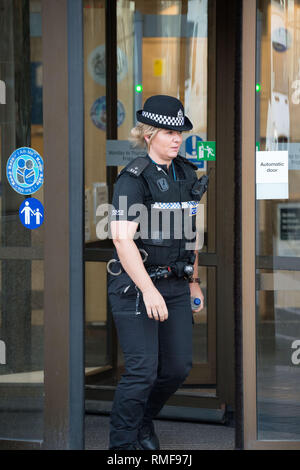 Glasgow, UK. 14 February 2019. Police leave the court during Alesha McPhail's Murder Trial. Alesha's body was found in the grounds of a former hotel on 2 July last year.  Not able to name the accused. It is illegal in Scotland to publish the name, address, school or any other information which could identify anyone under the age of 18 who is the accused, victim or witness in a criminal case  This law applies to social media as well as to websites, newspapers and TV and radio programmes. Credit: Colin Fisher/Alamy Live News Stock Photo