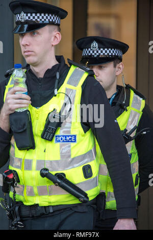 Glasgow, UK. 14 February 2019. Police leave the court during Alesha McPhail's Murder Trial. Alesha's body was found in the grounds of a former hotel on 2 July last year.  Not able to name the accused. It is illegal in Scotland to publish the name, address, school or any other information which could identify anyone under the age of 18 who is the accused, victim or witness in a criminal case  This law applies to social media as well as to websites, newspapers and TV and radio programmes. Credit: Colin Fisher/Alamy Live News Stock Photo