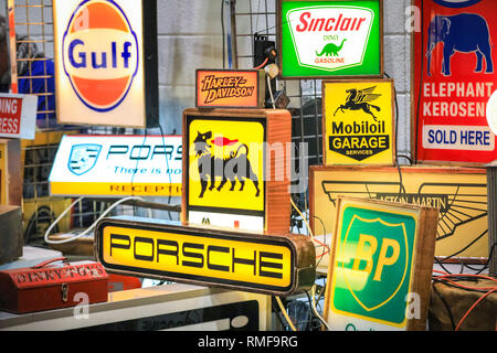 ExCel, London, UK, 14th Feb 2019. Illuminated car and petrol station signs.The London Classic Car Show 2019 opens at ExCel Exhibition Centre in London Docklands. The show  brings together classic car owners, collectors, experts and enthusiast with dealers, manufacturers and car clubs in a celebration of motoring and classic cars. Credit: Imageplotter News and Sports/Alamy Live News Stock Photo
