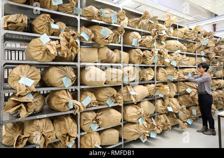 Neubrandenburg, Germany. 05th Feb, 2019. Heike Thieme, head of the archive, stands in front of shelves with paper sacks filled with torn files at the Neubrandenburg branch office of the Federal Commissioner for Stasi Files BStU. At a press conference on 15.02.2019 in Schwerin, Anne Drescher, the state commissioner for the Stasi files, will inform Anne Drescher about current priorities, events and publications of the BStU and about the work in the previous year. Credit: Bernd Wüstneck/dpa/ZB/dpa/Alamy Live News Stock Photo