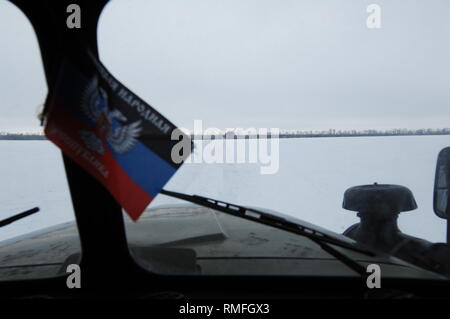January 17, 2019 - Donetsk, Donetsk Peoples Republic (DPR) D, Ukraine - View of the front line position that's not accessible by 4wd, only a heavy duty army truck. A DPR flag is seen in the windscreen.The war between the Ukrainian army and the soldiers of the Donetsk Peoples Republic has cost the lives of 12,000 people and those who have been displaced exceed a million. It escalated in 2014. Despite a ceasefire in place, it is evident that death still occurs from predominantly, sniper, mortar and mines.The construction of trenches either side of no-man's land, (often only 100mt apart) have Stock Photo