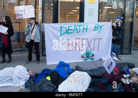 London, UK. 15th Feb, 2019.  No to death by Brexit campaigners stage a stunt outside Dept of Health and Social Care headquarters opposing the lack of clear guidance that medical supplies will be maintained after Brexit. The stunt was people in sheets of body bags lying outside the entrance at 39 Victoria Street, London SW1 Credit: Bruce Tanner/Alamy Live News Stock Photo