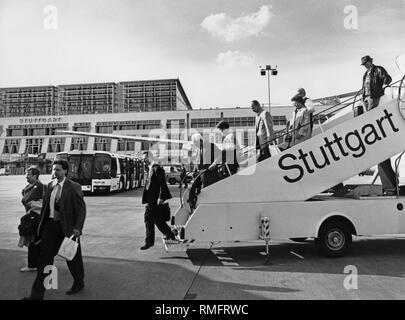 Passengers leave an airplane on the apron of the Stuttgart airport. Stock Photo