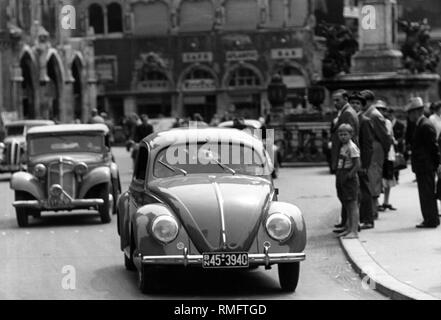 Busy city traffic on Marienplatz in Munich. The picture shows a VW Beetle. Stock Photo