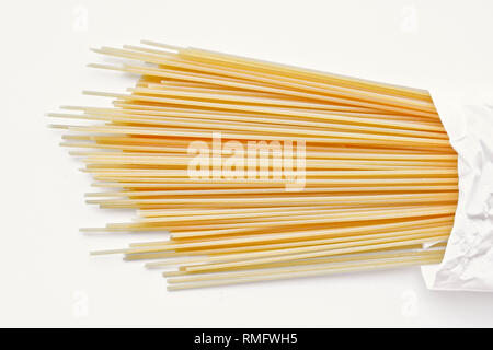 Yellow long spaghetti on a light background. Thin pasta arranged in rows. Italian raw pasta. Food background Stock Photo