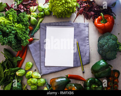 Fresh vegetables flatlay overhead frame. Notebook with vegetables.. Food layout. Diet. Dieting plan Stock Photo