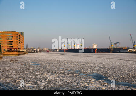 Port of Hamburg in Winter with frozen river Elbe Stock Photo