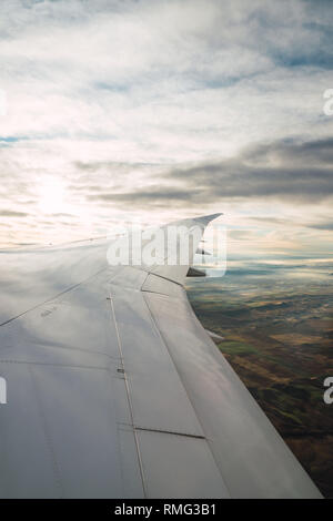 Bearded passenger using device in aircraft Stock Photo